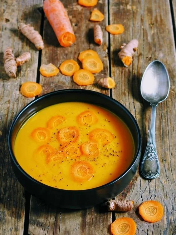 Delicious carrot soup with turmeric and butternut served in a bowl.