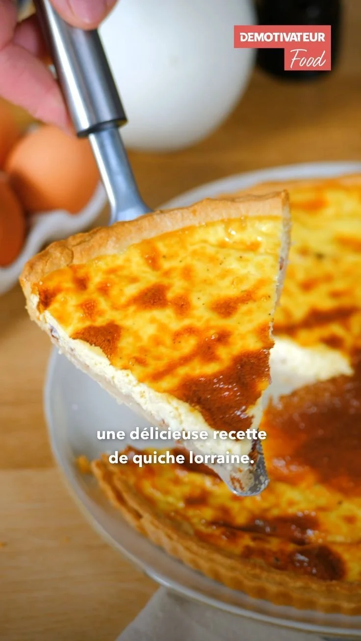 Delicious homemade quiche lorraine served on a rustic wooden table.
