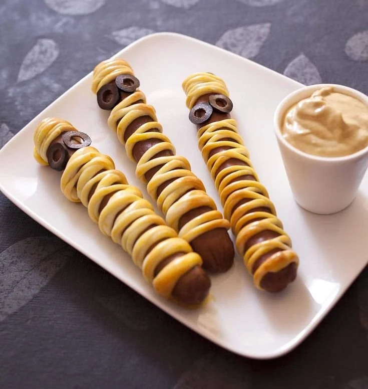 Recette de saucisses momie pour Halloween, accompagnées d'idées de décoration festive.
